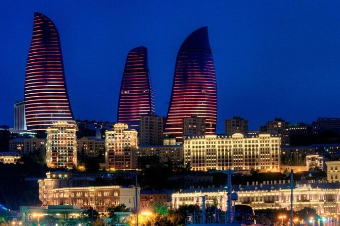 Baku City Sights Guided Night Walking Tour with Funicular - Baku after sunset, with the Flame Towers overhead